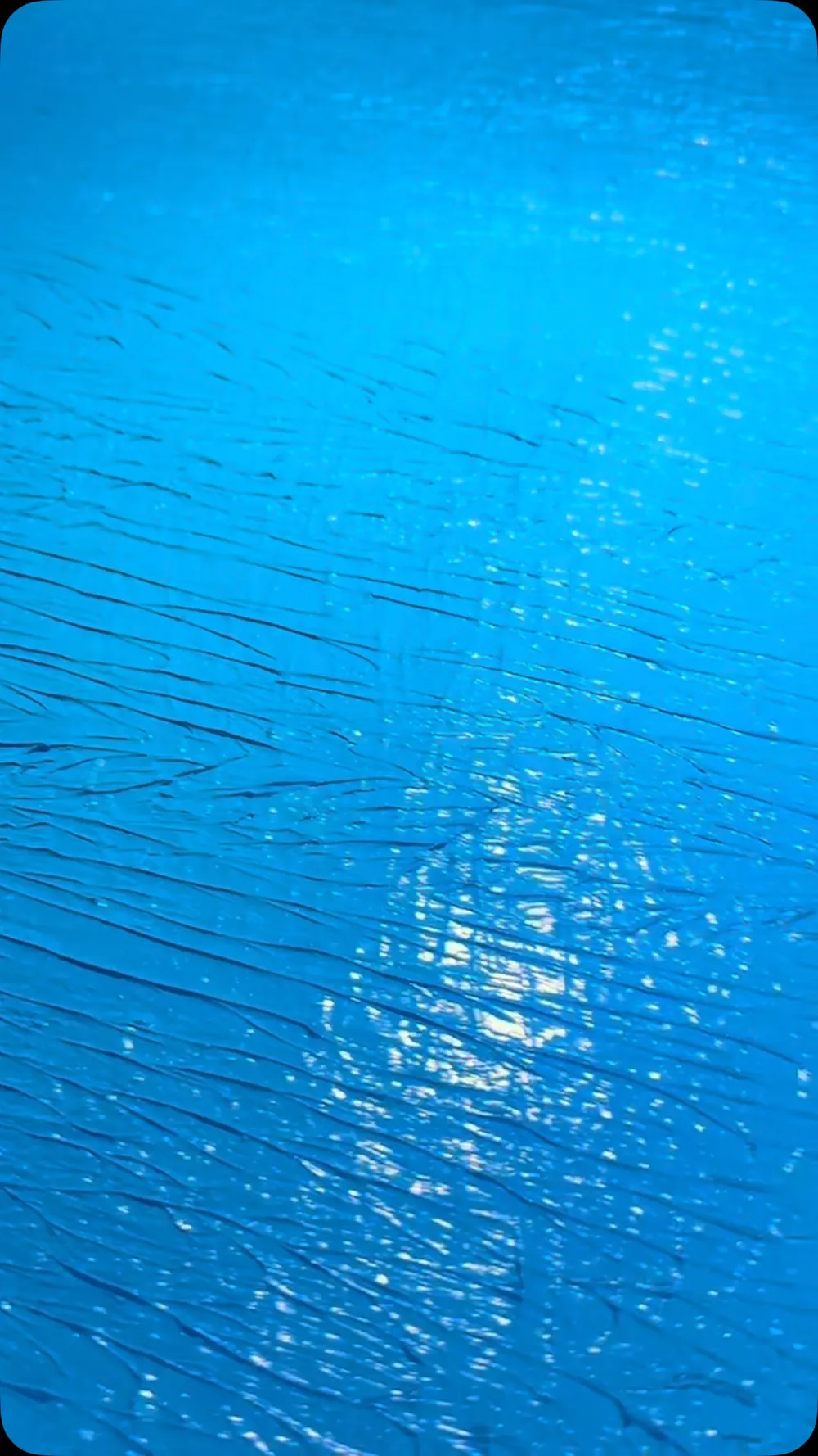 Freshly coated balcony floor in glossy electric blue ACTFLEX 906, roller texture catching the light