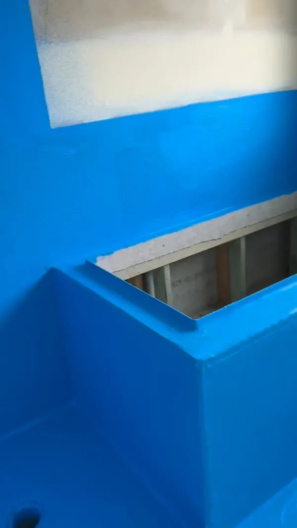 Bathroom floor and hob membraned in blue, with a floor waste